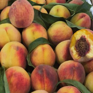 A vibrant display of fresh ripe peaches, perfect for summer's healthy meals.